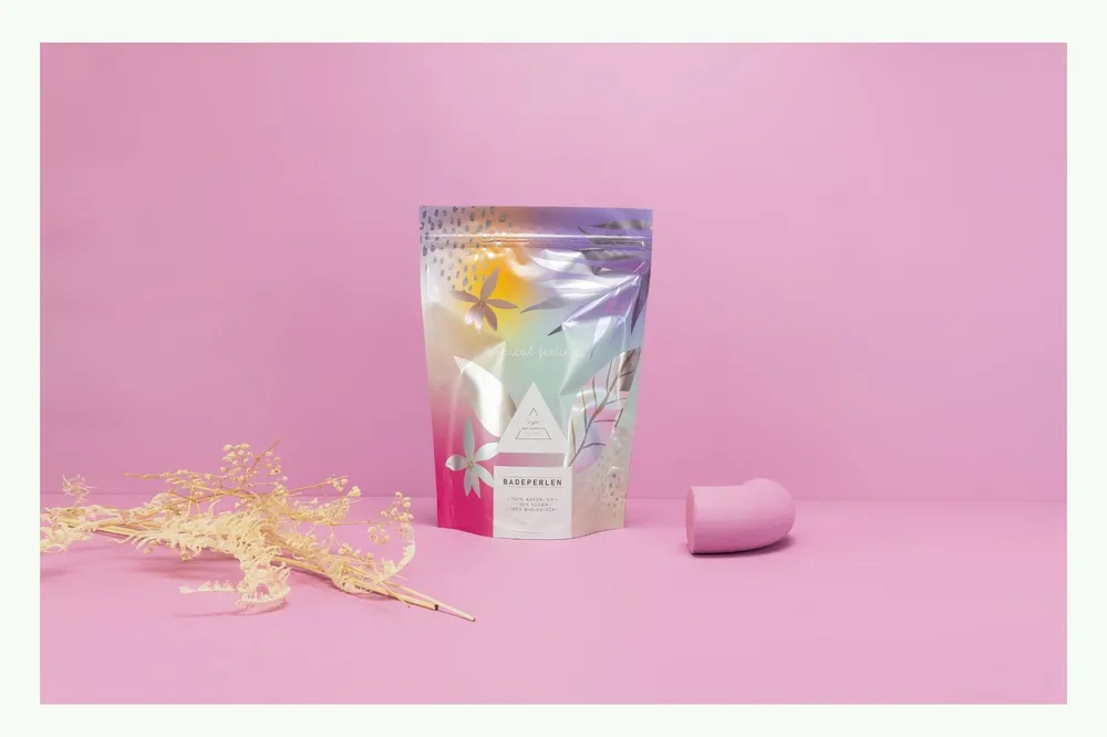 A printed stand-up pouch with yellow design against pink background A printed stand-up pouch with yellow design against pink background