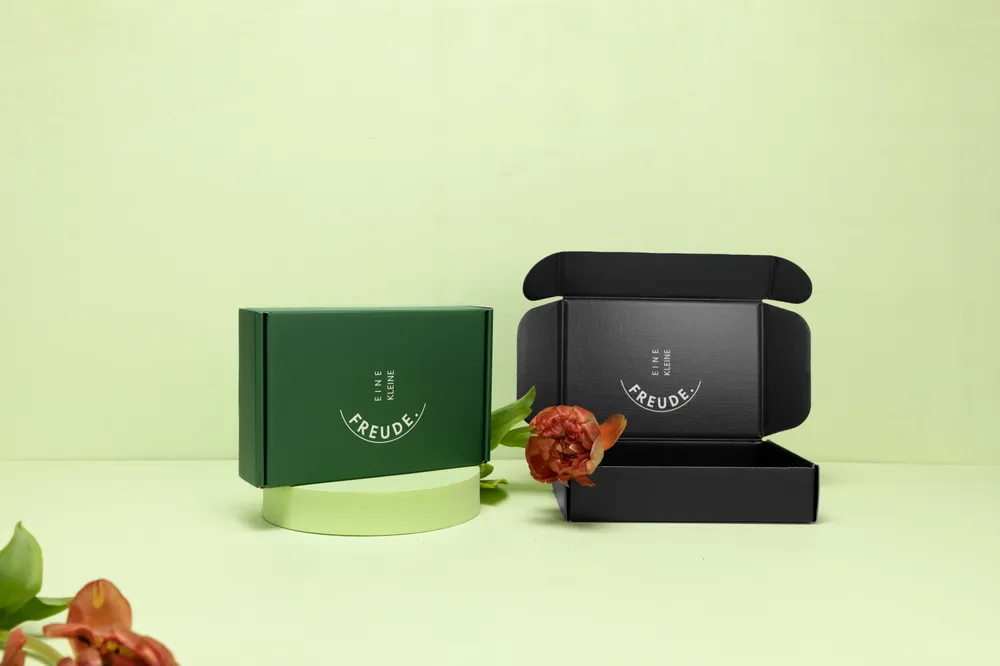 Opened product boxes in green and black on a light background Opened product boxes in green and black on a light background